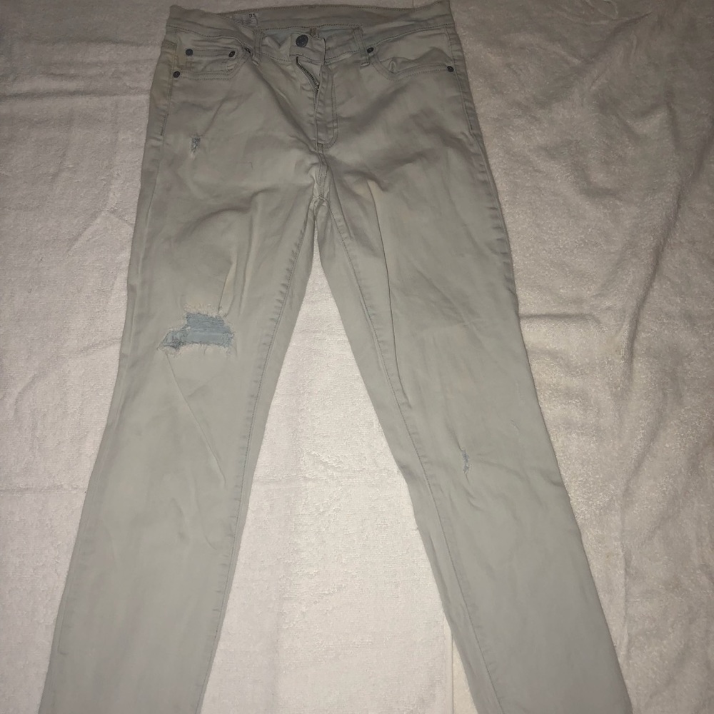 Light blue jeans with distressed knee.